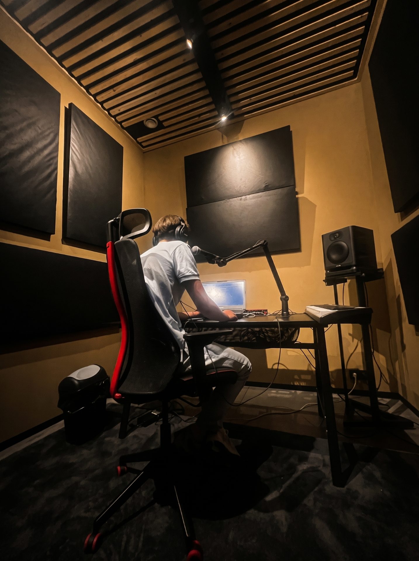 A producer working at the desk in a Temple Studios production room